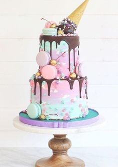 a three tiered cake with chocolate and pink icing, decorated with confetti