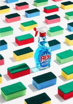 a bottle of mouthwash sitting on top of colorful sponges