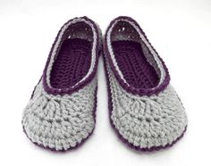 two crocheted slippers sitting on top of a white surface