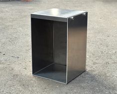 an empty metal box sitting on the ground