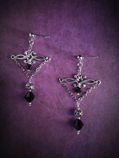 Introducing our exquisite Gothic Victorian Style Chandelier Earrings! These striking statement pieces are a perfect blend of elegance and edge, designed for the adventurous souls who embrace the dark side of fashion. Each earring showcases a captivating arrangement of intricate filigree work inspired by the opulent era of Victorian gothic architecture. The shimmering black onyx teardrop pendants dangle gracefully, adding a touch of mystery and glamour. Crafted with meticulous attention to detail, these earrings are lightweight and comfortable to wear, making them an ideal accessory for any special occasion or evening ensemble. Channel your inner romantic goth with these enchanting chandelier earrings that effortlessly combine vintage charm with contemporary allure. Each product is one of a Gothic Dangle Earrings For Wedding, Fantasy Style Pierced Earrings For Party, Gothic Jewelry Diy, Victorian Gothic Jewelry, Goth Earrings, Diy Jewelry Projects, Elegant Gothic, Romantic Goth, Gothic Victorian