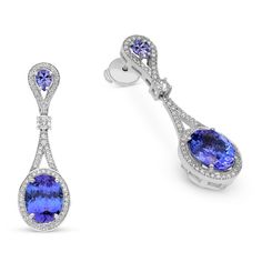 Raise the fashion bar with these alluring blue tanzanite and diamond drop earrings. Created in 18K white gold, each dangle shimmers with diamonds to highlight an oval-cut blue tanzanite framed by a diamond pave halo. Diamonds line the unique drop design to complete this elegant look. 11.69 carat Oval cut Tanzanite earrings 1.14 carat white diamonds The earring design can be customized to suit your particular taste & budget with any Size, Color & Clarity Combination of Certified Natural D Tanzanite Drop Earrings, Emerald Earrings Drop, Tanzanite Earrings, Drop Design, Blue Tanzanite, Women Diamond, Tennis Bracelet Diamond, Diamond Drops, Dangling Earrings