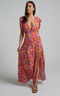 Be a spring dream in our Dyliah Maxi Dress! This incredible dress features a plunge neckline, frill detail on the shoulders, fitted waist and a thigh high split. It's a 10/10 ensemble that'll have you feeling  yourself from head to toe!Product Details  Invisible zipper on the centre lower backSelf-tie detail at back of neckSelf-tie waist tiePlunge necklineCut out detail at backFrill detail on shouldersThigh high splitMaxi lengthPartially lined - bodice onlyNo pocketsSize & FitSize S / 8 Beach V-neck Ruffle Maxi Dress, Beach V-neck Maxi Dress With Ruffles, Maxi Length V-neck Ruffled Beach Dress, Feminine V-neck Maxi Dress For Vacation, Flirty V-neck Maxi Dress For The Beach, Elegant Floral Print Dress With Split, Fitted V-neck Floor-length Summer Dress, Flirty V-neck Floral Print Dress, Summer V-neck Lined Maxi Dress