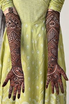 a woman with henna tattoos on her hands