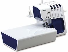 a white and blue sewing machine sitting on top of a table