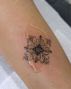 a woman's arm with a tattoo design on the left side of her body