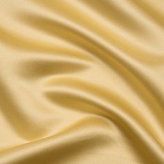 a close up view of a gold satin fabric