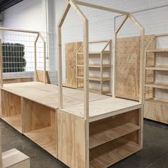 several wooden shelves and shelving units in a warehouse