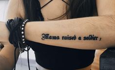 a woman with a tattoo that reads mama raised a soldier on her left arm and the words mama raised a soldier written in black ink