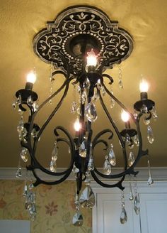 a chandelier hanging from the ceiling in a room