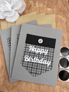 three greeting cards with the words happy birthday printed on them, sitting next to some craft supplies