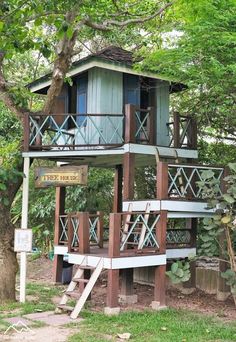 a tree house with stairs leading up to the top and second story on stilts