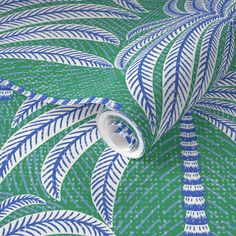 a green and white wallpaper with blue leaves