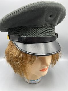 "Vintage Army Green Dress Military Hat  Lots of detail on this vintage hat, including a nice eagle emblem brass button on each side. The hat is in excellent condition, very solid with no tears or stains. The shape is good and stiff as it should be. It is lined with gold fabric and is embellished with a black vinyl  2 1/2\" brim and black had band that is attached to the eagle buttons and goes across the front. It appears that there may have once been a medallion pin on the front top section, as Black Military Brimmed Hat, Black Brimmed Military Hat, Military Style Hat With Curved Brim, Classic Fitted Visor Hat, Military Style Hat With Short Brim, Vintage Military Visor Hat, Classic Adjustable Cloche Hat Flat Cap, Vintage Military Cap, Classic Adjustable Cap For Costumes