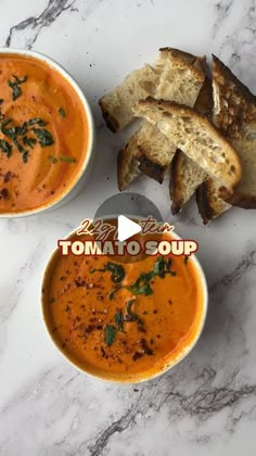 two bowls of tomato soup next to slices of bread on a marble counter top with the words tomatio soup