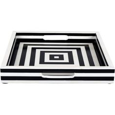 a black and white striped tray with a square design on the bottom, in front of a