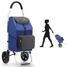 a woman is walking with a blue stroller next to a large bag on wheels