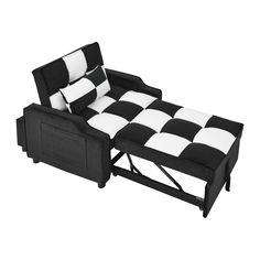 a black and white checkered couch with two pillows on the back, sitting in front of a white background