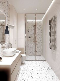 a bathroom with a sink, toilet and shower stall in the middle of the room