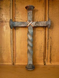 an old metal cross on a wooden surface