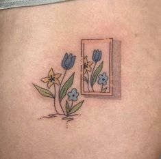 a woman's stomach with flowers on it and a mirror in the back ground