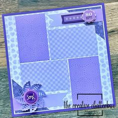 a close up of a card with purple and white designs on the front, along with a blue ribbon