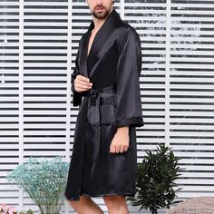 This Men's Black Satin Silk Long Sleeve Robe is made from high-quality satin silk, making it a luxurious choice for lounging. The lightweight fabric is comfortable and breathable, with an elegant drape. The long sleeves provide a classic silhouette for a timeless look. 95% Polyester, 5% Spandex Imported Tie closure Machine Wash Black Long Sleeve Robe For Fall, Elegant Long Sleeve Night Robe, Formal Fitted Long Sleeve Robe, Classic Long Sleeve Robe For Loungewear, Elegant Long Sleeve Robe, Fitted Long Sleeve Solid Color Robe, Elegant Solid Color Long Sleeve Robe, Elegant Long Sleeve Solid Robe, Elegant Long Sleeve Solid Color Robe