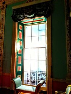 a chair sitting in front of a large window