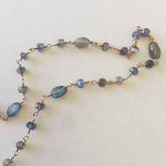 Simple Labradorite rosary Necklace with Toggle clasp. Length:15.5". Primary Chakras: Root/Heart/Throat/Third-Eye/Crown Chakra Labradorite properties: It is, in every sense, a Stone of Magic, a crystal of shamans, diviners, healers, and all who travel and embrace the universe seeking knowledge and guidance. For self-discovery, it is excellent for awakening one's own awareness of inner spirit, intuition and psychic abilities. Labradorite is also very protective against negative energies, balancing Spiritual Labradorite Jewelry With Gemstone Beads, Handmade Kyanite Healing Necklaces, Spiritual Kyanite Gemstone Beads Jewelry, Labradorite Gemstone Beads Necklace For Meditation, Spiritual Single Strand Jewelry With Oval Beads, Spiritual Single Strand Oval Bead Jewelry, Oval Labradorite Necklace For Jewelry Making, Oval Labradorite Necklace With Natural Stones, Labradorite Gemstone Crystal Necklaces With Round Beads