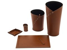 a set of three brown leather cups and trays