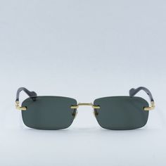 Introducing the Gucci GG1221S 001 Gold/Black/Grey sunglasses, a luxurious and sophisticated addition to your eyewear collection. Exclusively available at OSSA FRAMES, these designer glasses are sure to make a statement with their sleek design and high-quality craftsmanship. Crafted from premium metal, the frame of these sunglasses boasts a stunning gold finish that exudes elegance and glamour. The rectangular shape of the frame adds a contemporary touch to the design, making them perfect for the modern man who values both style and practicality. The subtle black accents on the temples add a touch of sophistication to the overall look. The lenses of the Gucci GG1221S sunglasses feature a chic grey tint that not only protects your eyes from harmful UV rays but also adds a touch of mystery an Gucci Gold Rimless Sunglasses, Gucci Rimless Mirrored Sunglasses, Luxury Rimless Sunglasses With Tinted Lenses, Luxury Rimless Polarized Sunglasses, Grey Sunglasses, Designer Glasses, Black Accents, Modern Man, Gold Finish