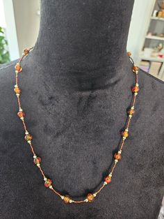 "24\" necklace  Round glass beads filled with orange,  gold, and green. The colors are subtle,  so they just form a nice blend inside the bead.  Magnetic closure Great for any casual or office attire.  This necklace is in very good condition.  All of my merchandise comes from a smoke-free environment.  Thank you for visiting my shop❣️" Orange Glass Beaded Jewelry, Orange Beaded Glass Necklaces, Orange Glass Beaded Necklace With Colorful Beads, Orange Round Glass Bead Jewelry, Brown Long Necklace With Colorful Beads For Gift, Orange Glass Necklace With Colorful Beads, Adjustable Orange Czech Glass Necklace, Orange Beaded Long Necklace, Gift Brown Long Necklace With Colorful Beads