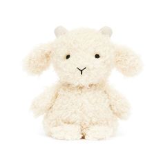 a white stuffed animal sitting up against a white background