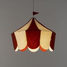 a red and white lamp hanging from a ceiling