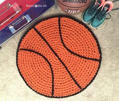 there is a basketball on the floor next to some shoes and a cup with coffee