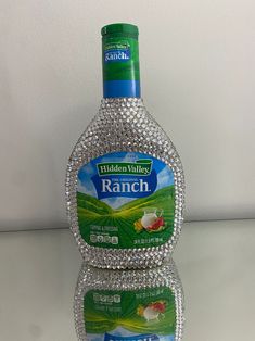 a bottle of hidden valley ranch on a white counter top with the reflection of another bottle