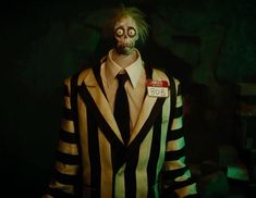 a creepy man dressed in striped suit and tie