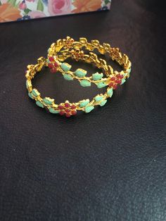 New addition flower and leaf bangles in stock. These bangles are perfect for matching dress, Size : 2.6 2 bangles pair In stock now and ready to ship. Hand crafted and gold plated kundan indian/pakistani jewelry Material:brass,stone,gemstone,pearl We bring you casual as well as party wear jewelry which comes with an attractive design and style. It goes well modern and traditional outfits. Visit my website for more collections https://www.etsy.com/shop/Noorzaracollection Bohemian Kundan Bracelets For Festivals, Handmade Green Bollywood Bracelets, Handmade Multicolor Kundan Bangle, Red Stone Work Bangle Jewelry, Red Bollywood Bangle With Stone Work, Traditional Handmade Party Bangle, Green Kundan Bangle In Bollywood Style, Green Kundan Bollywood Bangle, Green Kundan Bangle With Stone Work