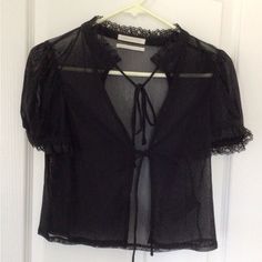 Black Sheer Short Sleeve, Lace Trimmed, Tie Front Shrug. Excellent Condition Never Worn. Crochet Shrug Short Sleeve, Sheer Black Button Up Shirt Outfit, Fitted Black Blouse For Daywear, Black Fitted Tops For Daywear, Fitted Black Top For Daywear, Short Sleeve Shrug, Sheer White Shirt, Sheer Sleeves Top, Sleeve Shrug