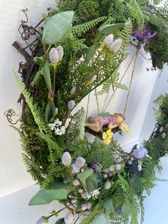 a wreath with flowers and plants on it