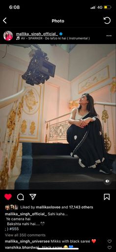 a woman sitting on top of a stair case