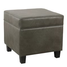 a gray ottoman sitting on top of a wooden table