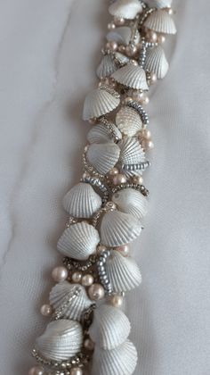 a necklace with seashells and pearls on it