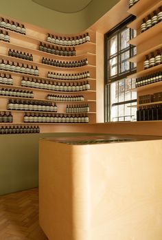 an empty counter in a store with bottles on the wall