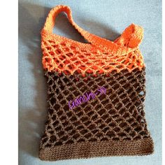 an orange and brown crocheted bag with the word stitching on it's side