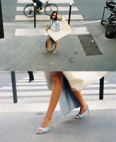 a woman sitting in a chair on the street with her legs crossed and feet crossed