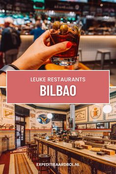 a person holding up a drink in front of a bar with the words luke restaurants bibao