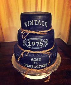 a three tiered cake with an aged to perfection sign on it's side