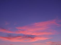 the sky is pink and purple with clouds