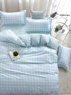 a bed with blue sheets and pillows on it